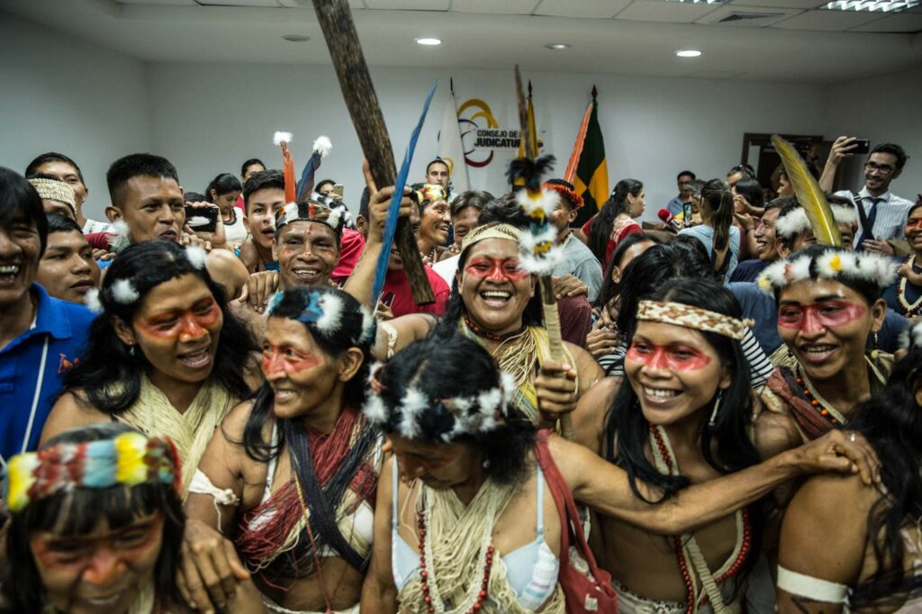 Waorani Indigenous leader Nemonte Nenquimo (second from right) celebrates a major legal victory that protects 500,000 acres of Amazonian rainforest and Waorani territory from oil extraction. Nemonte and Mitch Anderson are co-founders of Amazon Frontlines. Photo credit Mitch Anderson / Amazon Frontlines.
